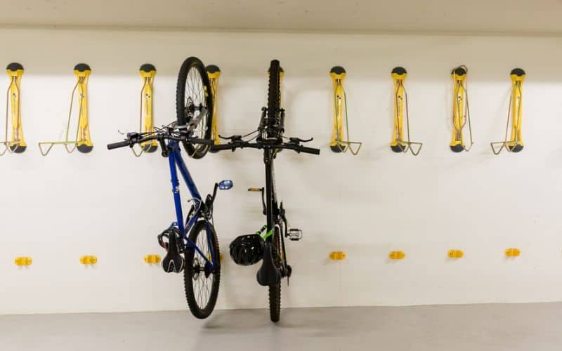 Bicycles hanging on wall mounted bike racks